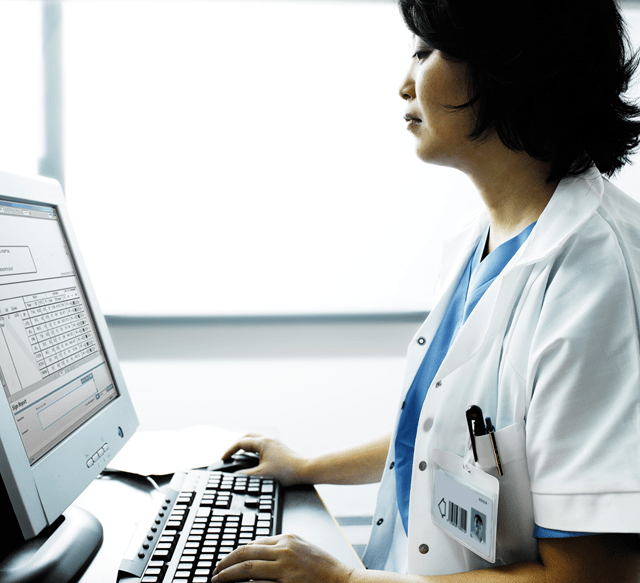 QA Portal - Image of a physician working on a computer